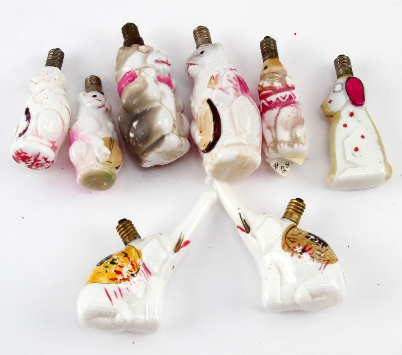 VINTAGE ANIMAL FIGURAL MILK GLASS CHRISTMAS LIGHTS: A collection of 8 early 20th century (pre-1946) animal figure Christmas lights. The lights include 3 Cat Playing Mandolin, 1 cat in a scarf, 1 dog in profile, 1 dog dressed as a clown (Pagliacci), and