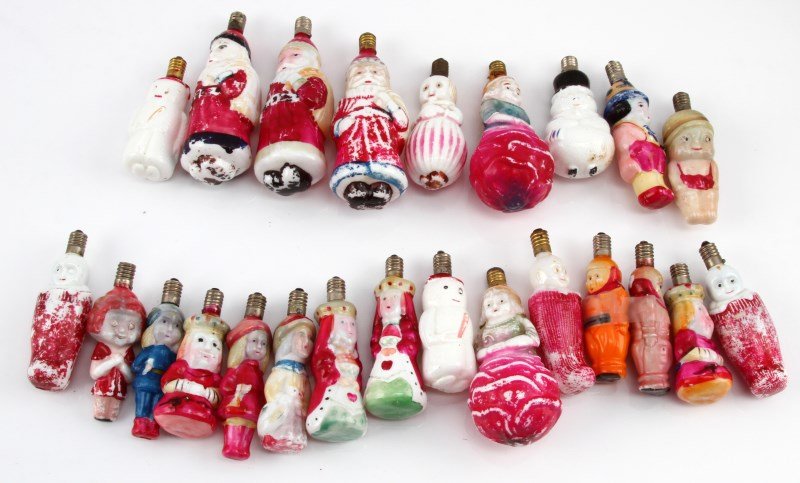 VINTAGE MILK GLASS FIGURAL CHRISTMAS LIGHTS: A collection of 24 early 20th century (pre-1946), hand-painted, milk glass, figural Christmas lights. The lights are made in Japan before the war. The figures include 3 Santa, 3 snowmen, 3 infants in 