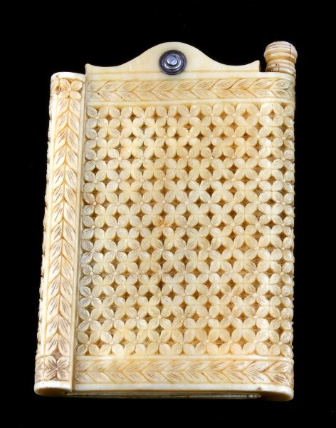 19TH CENTURY IVORY NOTEBOOK WITH IVORY PAPER: A very unique erasable notepad with pages made from ivory. The six ivory pages are as thin as 0.35mm thick. Includes screw out pencil. Geometric floral pattern. with white metal pivot point. Minor spl