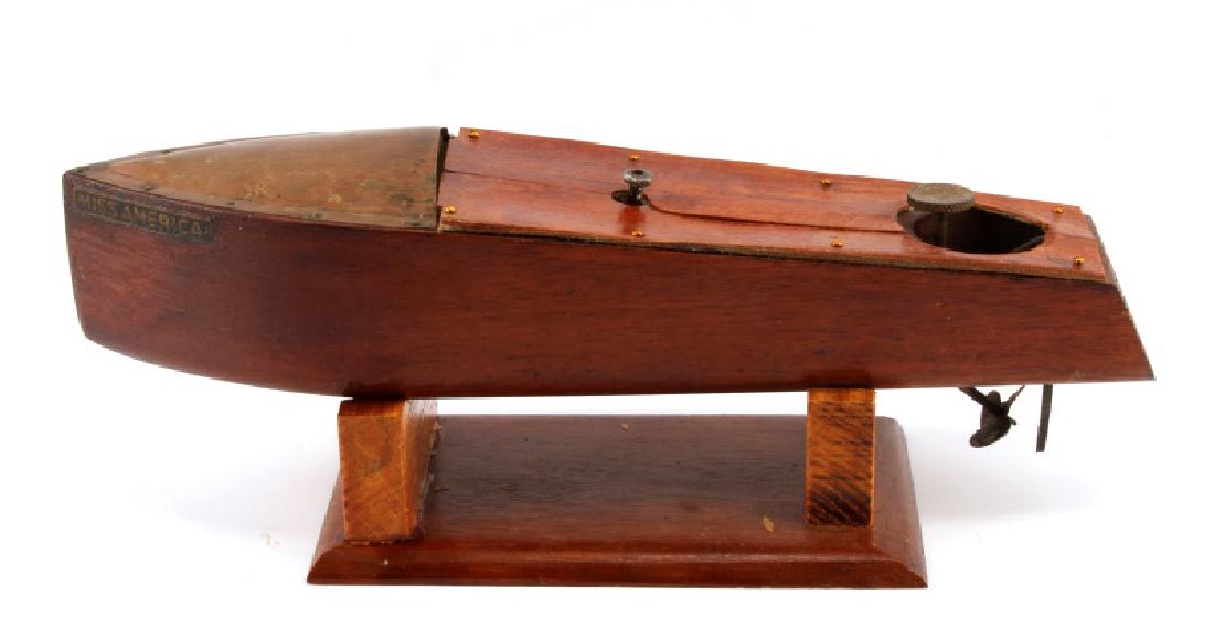 VINTAGE MENGEL PLAYTHINGS MISS AMERICA TOY BOAT: 1920's - 1930's Mengel Playthings toy wooden boat named Miss America. Brass spray hood, capstan, propeller, steering wheel, and rudder. Repair in wood to top center, Mengel marked to back, Miss Americ