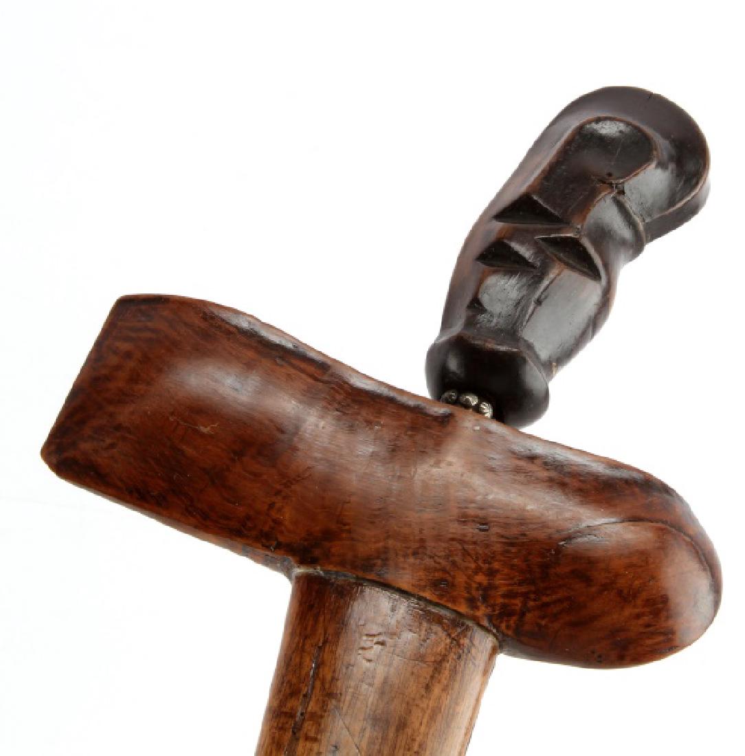 INDONESIAN SERPENTINE BLADE KRIS KERIS DAGGER: The sinuous or serpentine hand-forged Damascus steel blade measures 24-cm (9-1/2 inches). The carved wooden handle measures 9-cm in gross length (3-1/2 inches). No stirrups are present and the blade a
