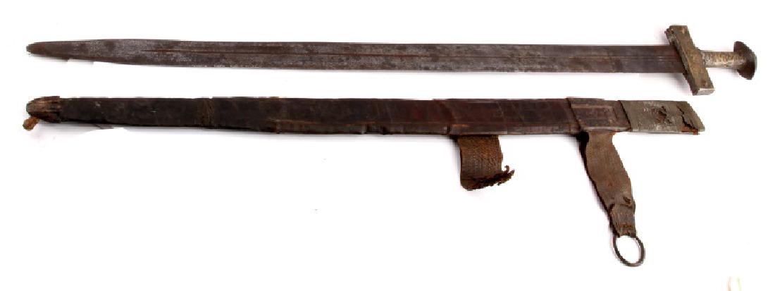 19TH CENTURY NORTH AFRICAN ENGRAVED SWORD: An antique sword from north Africa. The sword measures 38 inches (96.5 cm) in total length, with a 33 inch blade (83.8 cm). The hilt consists of a gross guard, handle and pommel cap, all made with han