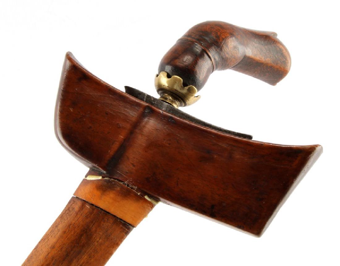 INDONESIAN DAMSCUS STEEL KRIS KERIS DAGGER: The sinuous or serpentine hand-forged Damascus steel blade measures 34-cm (13-1/4 inches). The angled, carved wooden handle measures 11-cm in gross length (4-1/4 inches). No stirrups are present and t