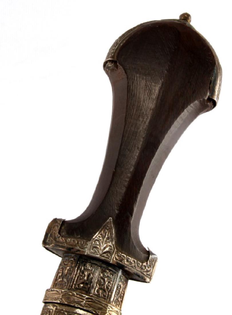 NORTH AFRICAN JAMBIYA KINDJAL W ENGRAVED SILVER: An ornate late 19th or early 20th century kindjal style dagger> Over all length is 37 cm (14-1/2 inches). The curved blade measures 22 cm in gross length (8-1/2 cm). The distal half of the convex edge
