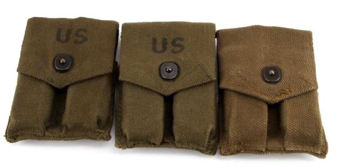 LOT OF THREE VIETNAM WAR ERA MAGAZINE POUCHES: Lot of three Vietnam War era magazine pouches. Pouches have two pockets each, holding two magazines. Two of the three are marked US in black letters on the front. Items feature a snap design to open a