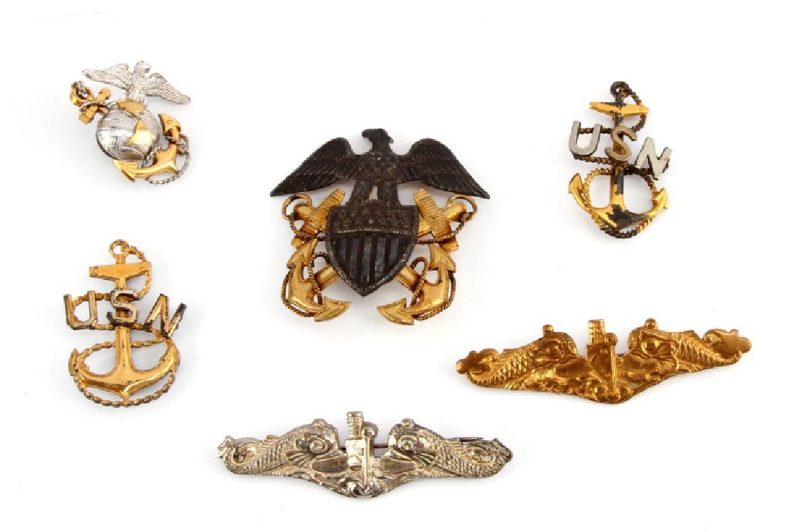 WWII & POST WAR US NAVY SUB PIN & CAP BADGE LOT: Includes two CPO cap badges one in sterling, officers cap badge in sterling and two twin dolphin submariner pins, the silver stamped Vanguard. Also sterling USMC EGA 38mm.