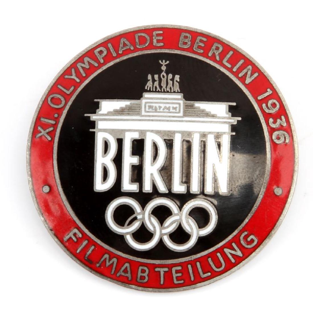 1936 BERLIN OLYMPICS FILM CREW FILMABTEILUNG PIN: Berlin Olympics Filmabteilung (film crew) with Bradenburg Gate. Marked "XI.OLYMPIADE BERLIN 1936 FILMABTEILUNG" Reverse marked "Rob. Neff Berlin W57". This lot has a reserve.