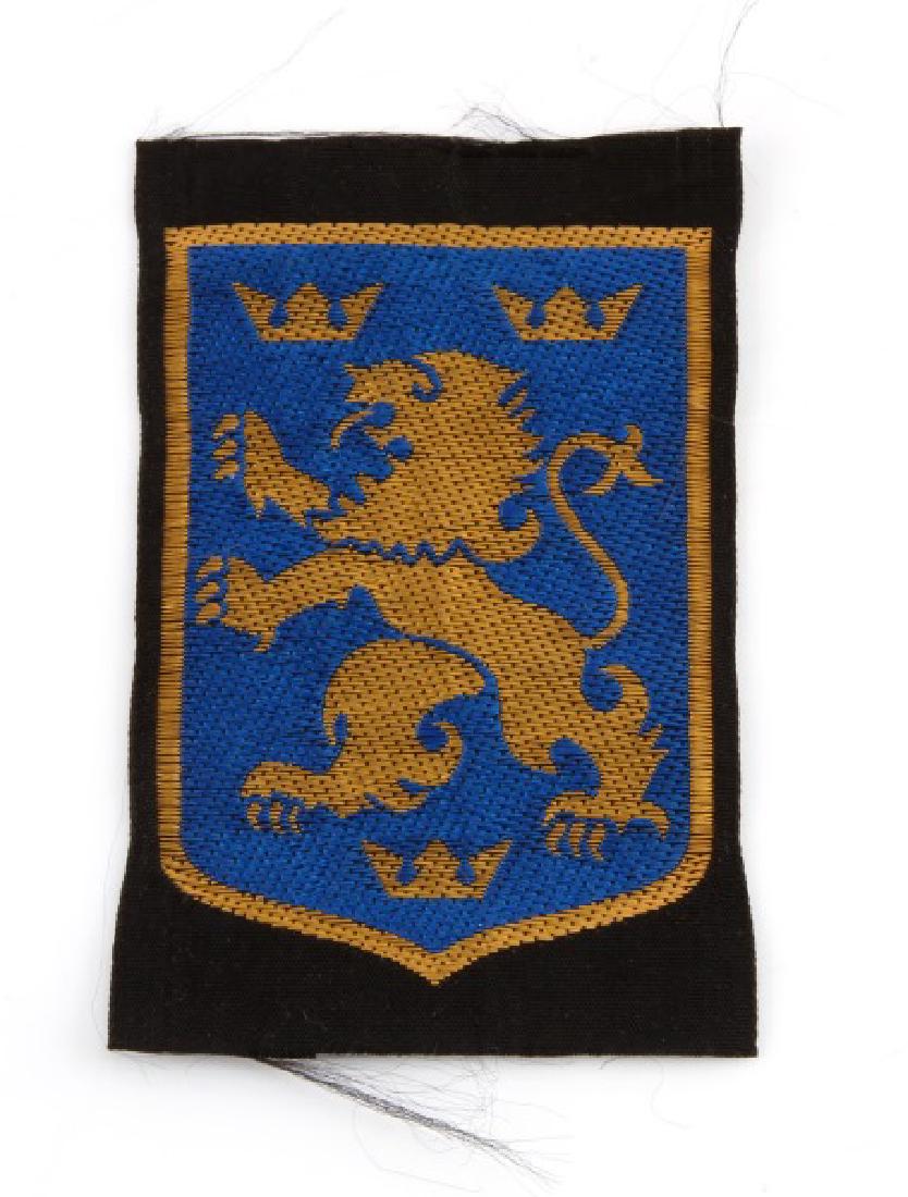 WWII GERMAN 3RD REICH UKRAINIAN DIVISION BADGE: A uniform arm patch from the 14th Waffen Grenadier Division of the SS (1st Galician). Prior to 1944 the division was known as the 14th SS-Volunteer Division with most members volunteering from the reg