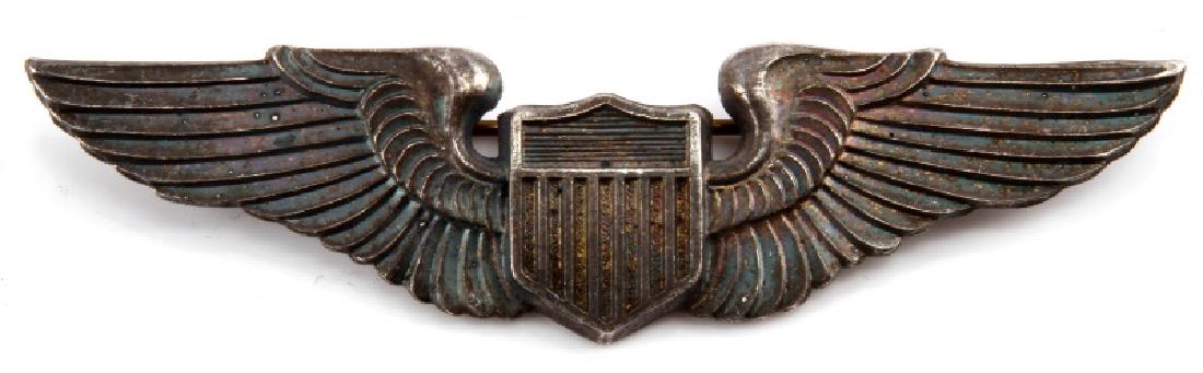 WWII USAAF STERLING US ARMY AIR FORCE PILOT WING: A United States Army Air Force (USAAF) sterling silver Pilot Wing measuring 3-1/16 inch wide by 13/16 inches tall. The reverse has a thin, English style 120-degree lie, C-clasp pin back. The reverse a