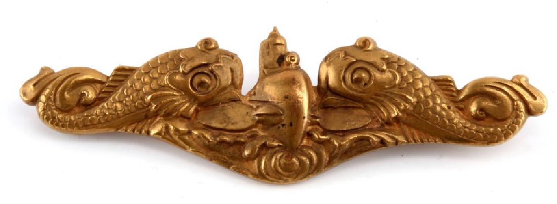 WWII RARE US NAVY SUBMARINE OFFICERS DOLPHIN BADGE: A rare United States Navy WWII Submarine Officer's Dolphin Badge measuring 2-7/8 inches wide by 7/8 inches tall. The reverse has a thin, 120-degree lie, English-style, C-clasp pin back, and bears the 