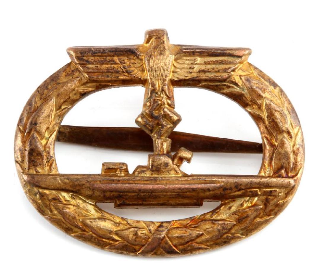 WWII GERMAN 3RD REICH U-BOAT SAILOR BADGE: A WWII German U-Boat Submarine sailor badge measuring 1-15/16 inches wide by 1-9/16 inches tall. The badge shows the port profile of a U-boat surrounded by an oval oak leaf wreath with a German eagle 