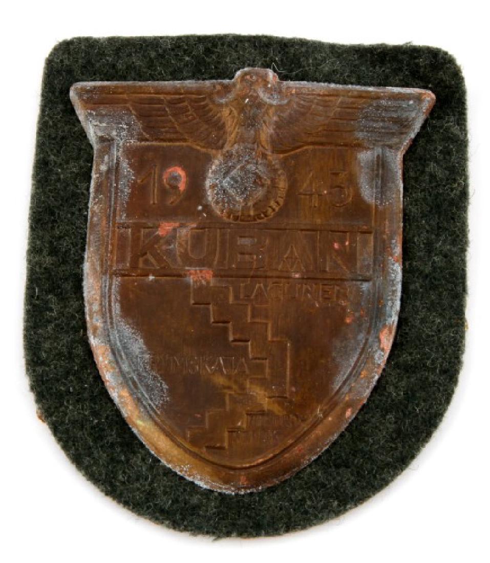 WWII GERMAN ARMY 1943 KUBAN SLEEVE SHIELD: A WWII German 1943 Ärmelschild Kuban (KUBAN Shield) awarded to those who fought at the Kuban Bridgehead in the Soviet Union from February 1943 until October 1943. The shield has a gray wool backing w