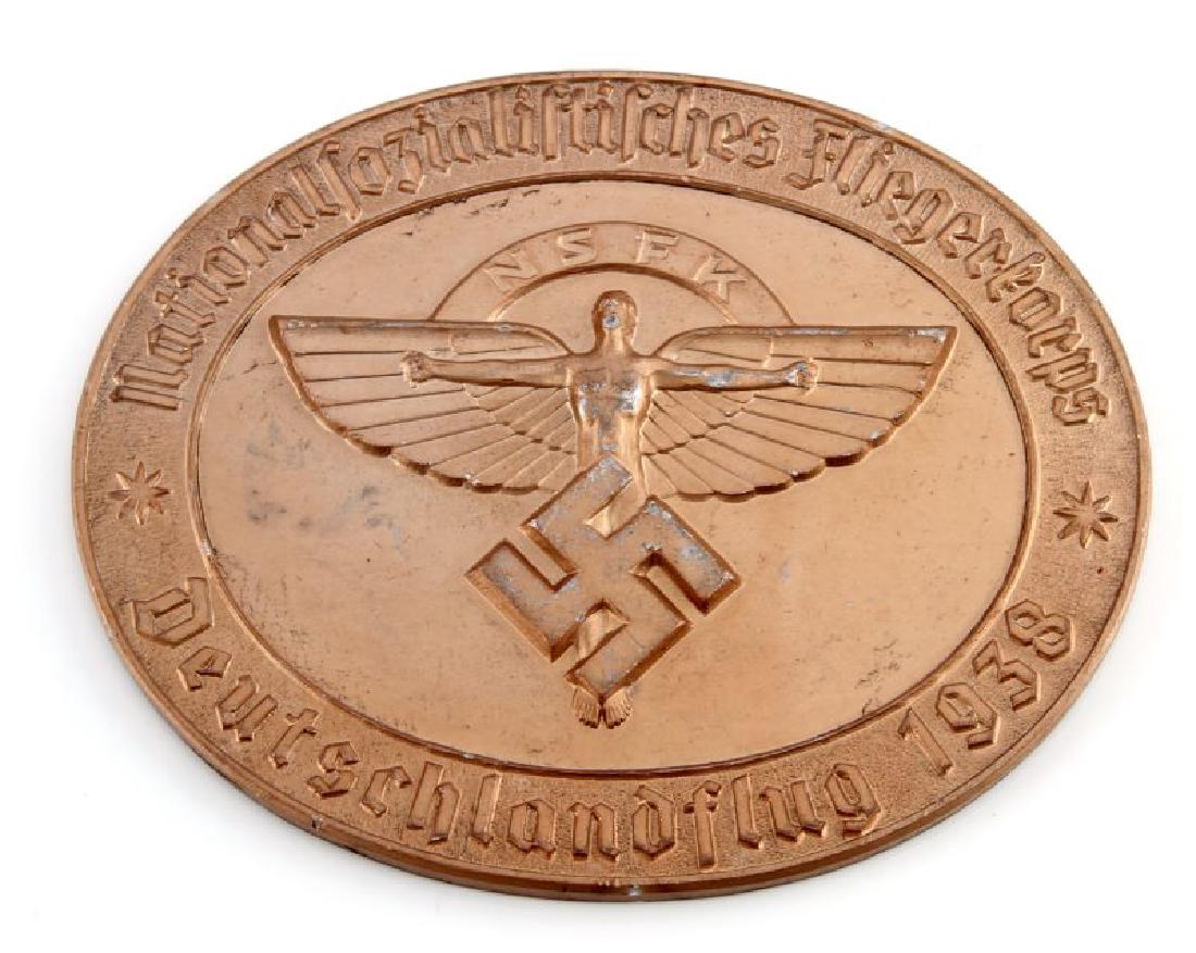 GERMAN WWII 1938 NSFK GLIDER KORPS TABLE AWARD: German WWII 1938 NSFK glider korps table award. Measures 3 3/4" wide by 3 1/16" tall. The front shows the winged man with 'NSFK' above with a swastika below. The reverse side has a presentation inscri