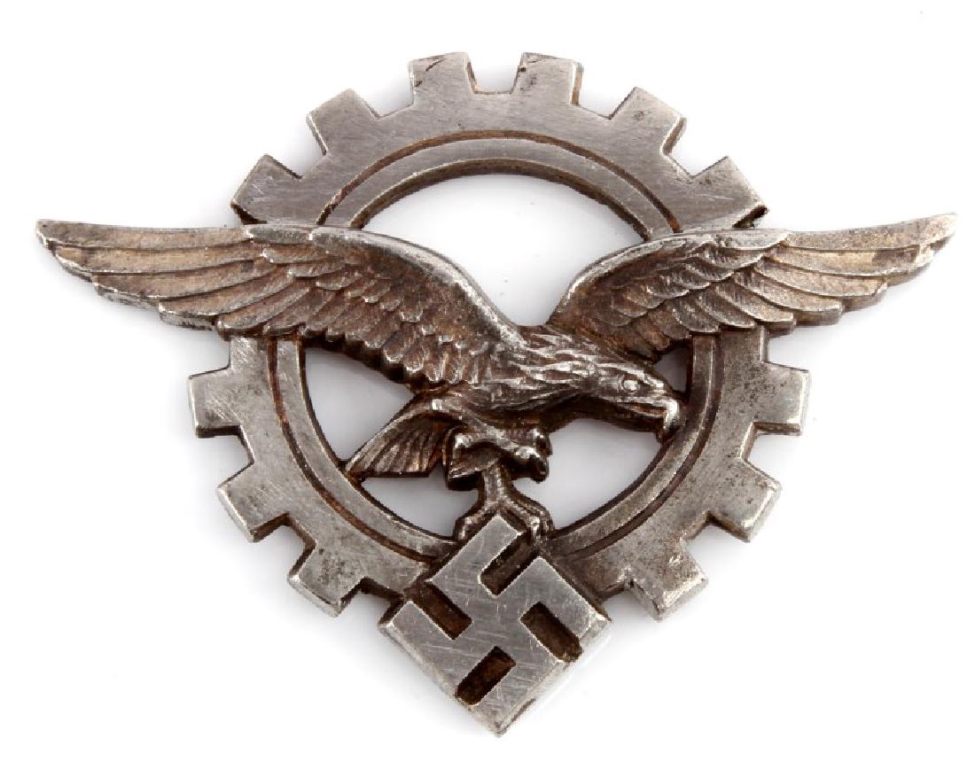 GERMAN WWII STUDENTBUND ENLISTED MANS BELT BUCKLE: German WWII Luftwaffe Technical Officers visor cap insignia. Measures 1 9/16" wide by 1 15/16" tall. The reverse side is maker marked 'ges gesch'. Has three flat prongs on the back. Stamped nickel con