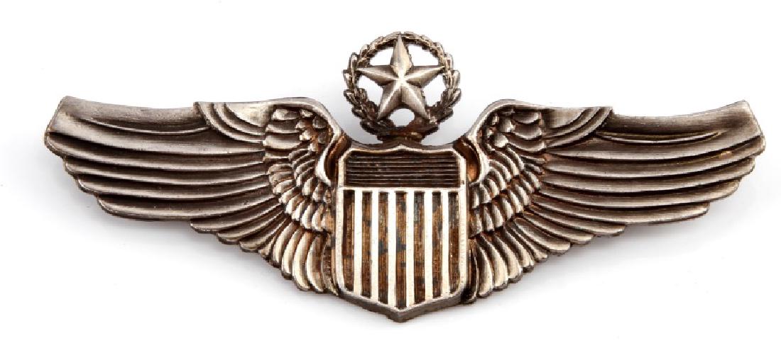WWII USAAF ARMY AIR CORPS COMMAND PILOT WING: A WWII United States Air Force Command Pilot Wing Badge measuring 3-1/8 inches wide by 1-1/4 inches tall. The reverse of the two piece nickel badge has a thin horizontal, 180-degree lie pin back and i