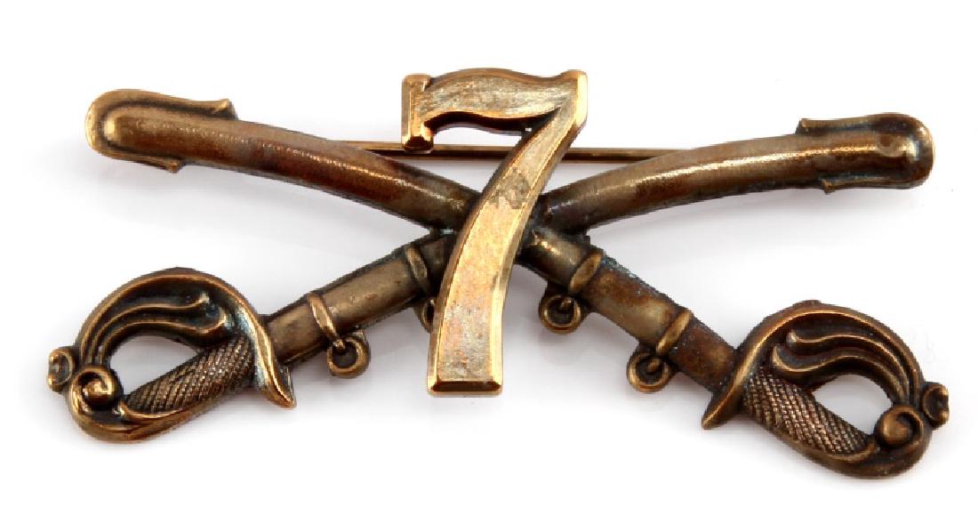 US INDIAN WARS ERA 7TH CAVALRY KEPI CAP BADGE: A United States Indian Wars Era 7th Cavalry Enlisted man's Kepi (Visor Cap) Cap Insignia Badge measuring 2-1/2 inches wide by 1 inches tall. The front of the badge shows the number "7" in front of cro