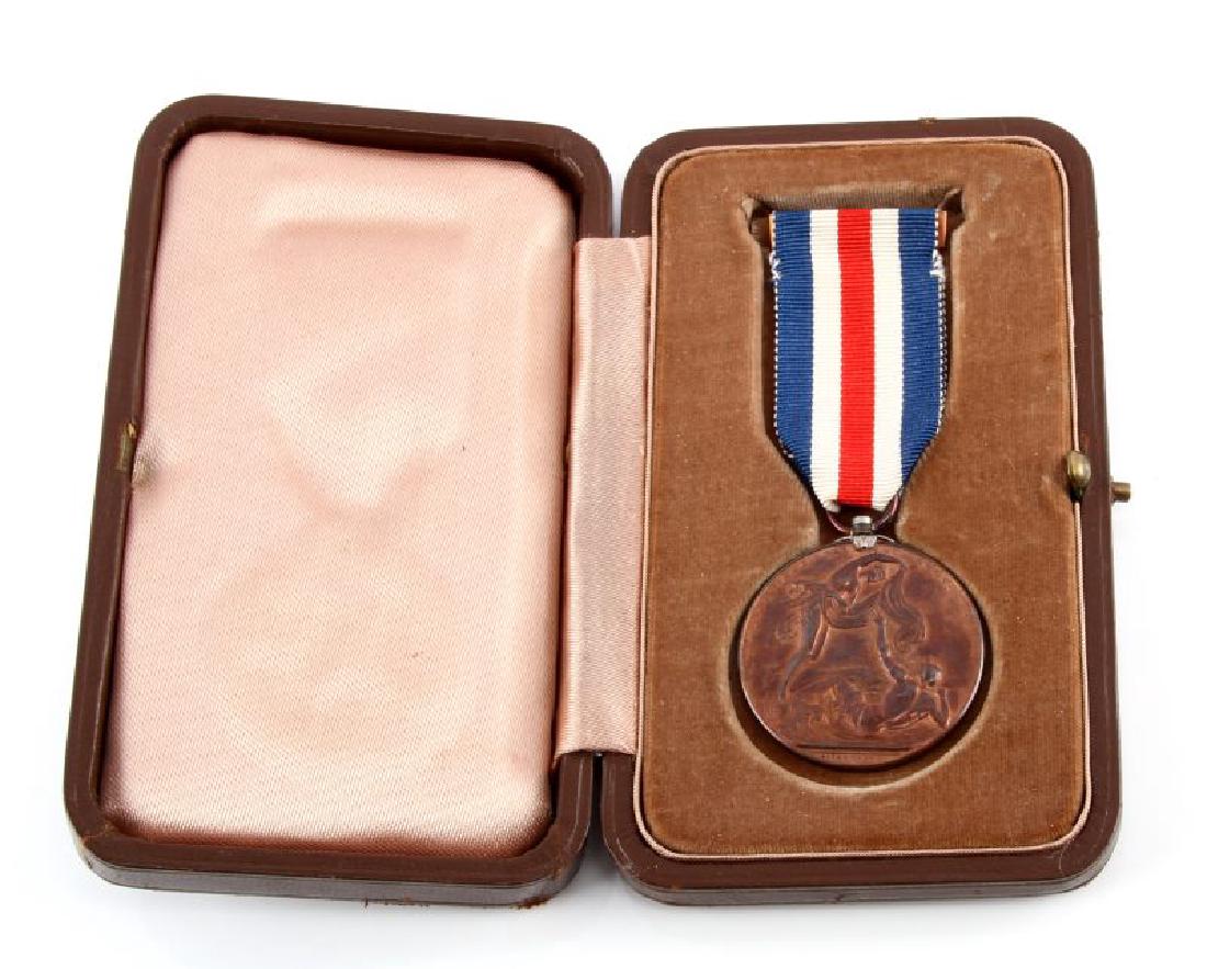 BRITISH LLOYD'S MEDAL FOR SAVING LIFE AT SEA CASED: Probably WWII-era. Bronze medal issued for assistance rendered in cases of shipwreck. Marked "Luecothoe naufrago succurrit" and reverse marked "Presented by Lloyd's Ob Cives Servatos" Design by W. Wyo