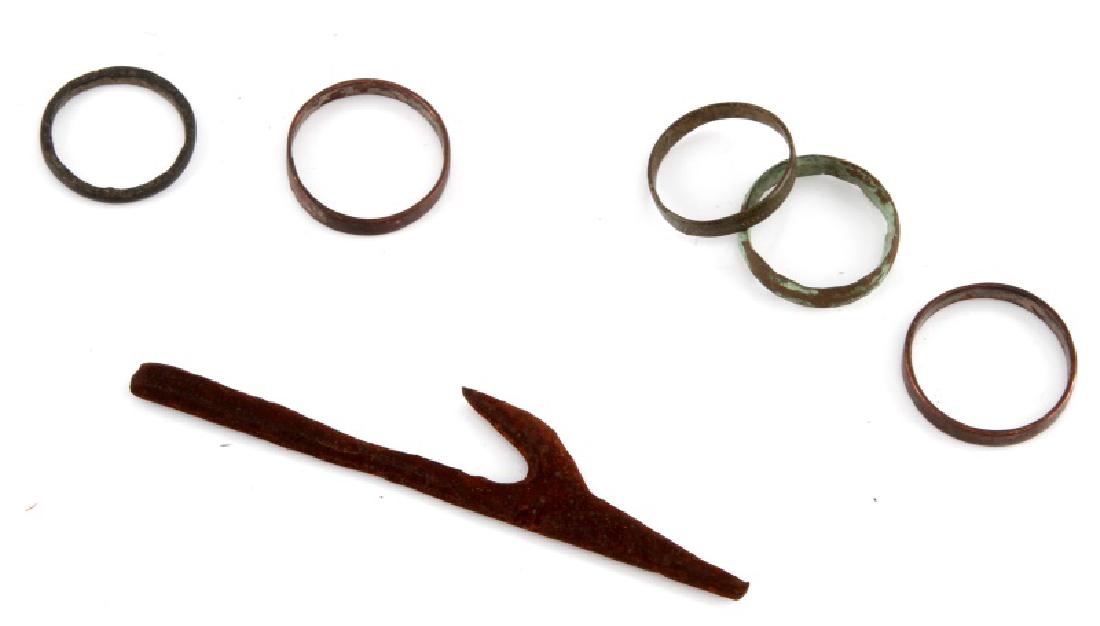 1800S IRAQUOIS TRADE RINGS AND FROG GIG: 5 trade rings and a frog gig. These were used by European traders to obtain fur pelts from the Iraquois. They come in a display case that measures 5 1/2" by 4 1/2". One of the rings has a coat of pati