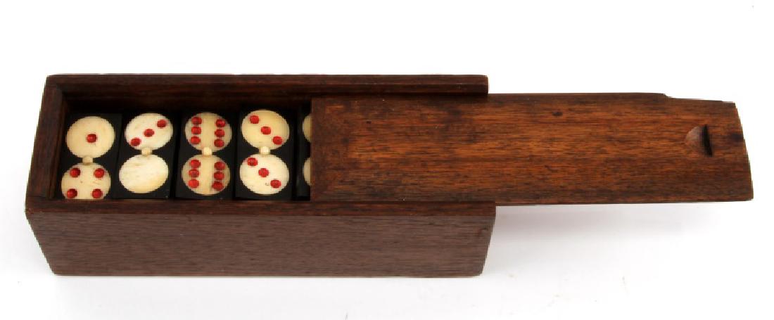 BONE AND EBONY DOMINO SET 28 PIECE: Each domino measures 1-5/8" x 3/4". Set is complete and includes case. Very good condition.