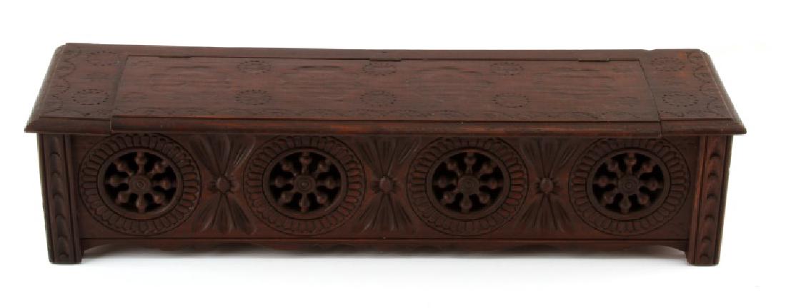 LONG VINTAGE WOODEN GLOVE BOX WITH FRETWORK: Intricately carved wooden box that measures approximately 15 1/2" across, 4" tall, and 4" deep. Could have been used as a glove box or to store incense sticks. Has a hinged top and a maker's mark on t
