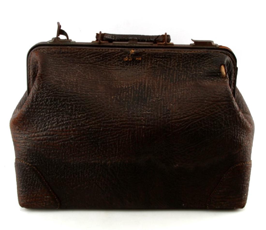VINTAGE TO ANTIQUE DOCTOR'S SHARK LEATHER BAG: Vintage to antique Doctor's house-call bad made of genuine Shark Leather marked "SHARK" on the bottom face of bag, measuring 18'' by 14'' by 10'' and has a leather handle with 2 brass locks on spine o