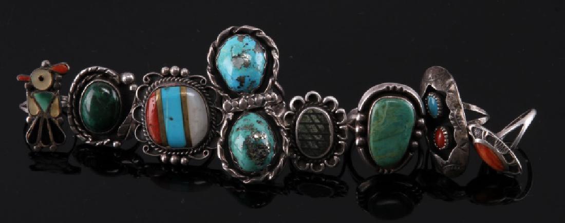 DEALERS LOT OF 8 STERLING SILVER RINGS: Consisting of: Elongated ring with 2 turquoise stones size 9, elongated ring with turquoise and coral stone size 6, round ring with turquoise coral and white stones size size 7.5, bird ling inlaid wit