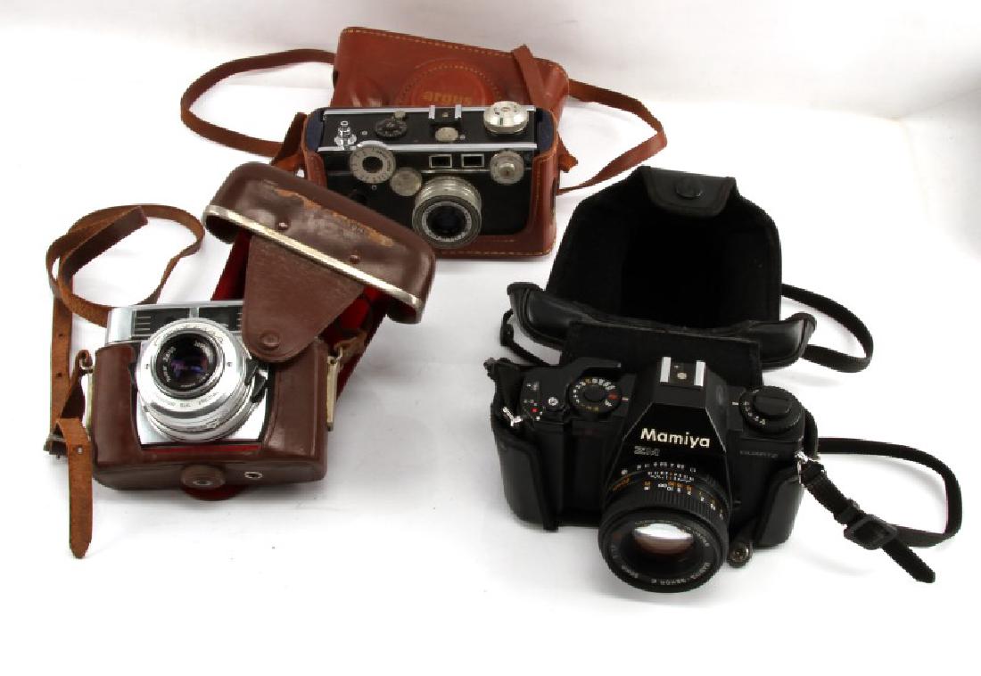 LOT OF 3 VINTAGE 35MM CAMERAS 1950S THROUGH 1980S: Three vintage cameras. Includes the Zeiss Ikon Contessa Prontor SLK; Argus C3 "The Brick" with a 50mm lens; and a 1982 Mimiya ZM Quartz camera with a 50MM lens. All come with leather cases. Only the M
