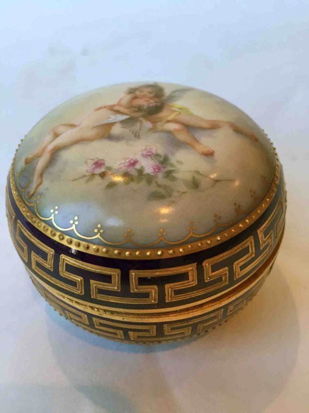 Ambrosious Lamm Dresden Porcelain Dresser Box c.1900: Expertly hand painted porcelain dresser jar painted with flowers to the interior cherubs and flowers to the top with raised gold gilt highlights c.1900. Fully marked for Lamm Dresden H: 2'' W: 2.75'' 