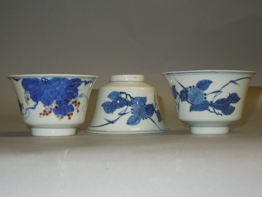 ANTIQUE CHIENSE CUPS: Three Chinese Blue White Under Red Glaze. D: 3 3/4"NOTE: ONE OF THE CUP IS BROKEN. THE DAY OF PREVIEW BROKE BY A CUSTOMER.
