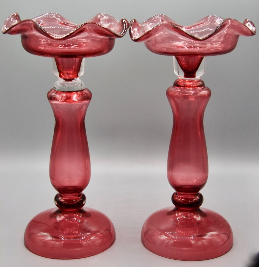 Pair of Cranberry glass candlesticks: Cranberry glass candlesticks, two count with wide flared rim, pedestal base, 12"H. Circa 1910