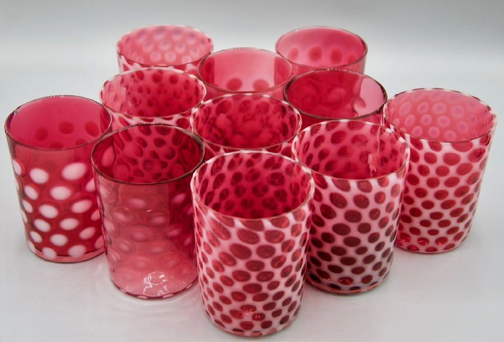 Cranberry glass tumblers, eleven count: Cranberry glass tumblers, eleven count in assorted pink to white hobnail pattern, early 20th century. 3.75" H.