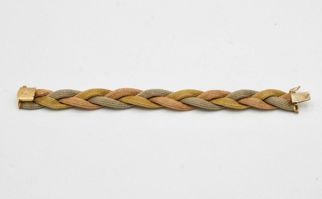 18 Karat tri-colored woven gold bracelet: 18 Karat tri-colored woven gold bracelet, marked 750 on clasp, 34.5 grams.