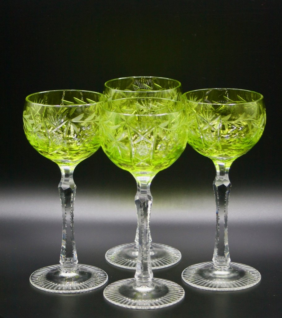 4 Bohemian celadon cut to clear hock wine glasses: Four count Bohemian celadon green cut to clear hock wine glasses, circa 1925. Glassware has a meandering grape vine cut glass pattern on bowl and six-sided clear stems with notch cut edges. Glasses te