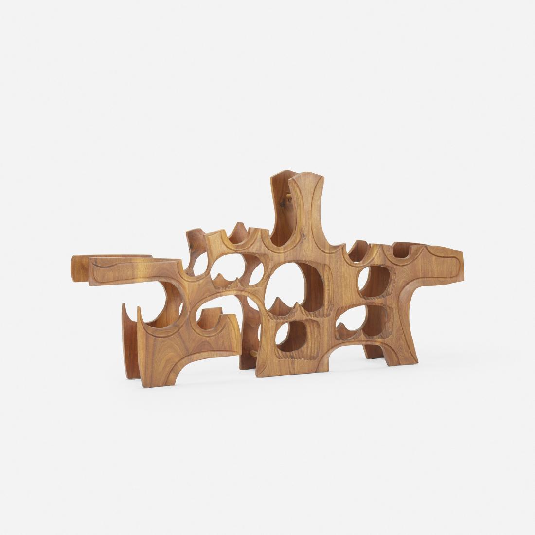 Federico Armijo, sculptural wine rack: Federico Armijo sculptural wine rack USA, c. 1975carved walnut56 w x 8 d x 28 h in (142 x 20 x 71 cm)