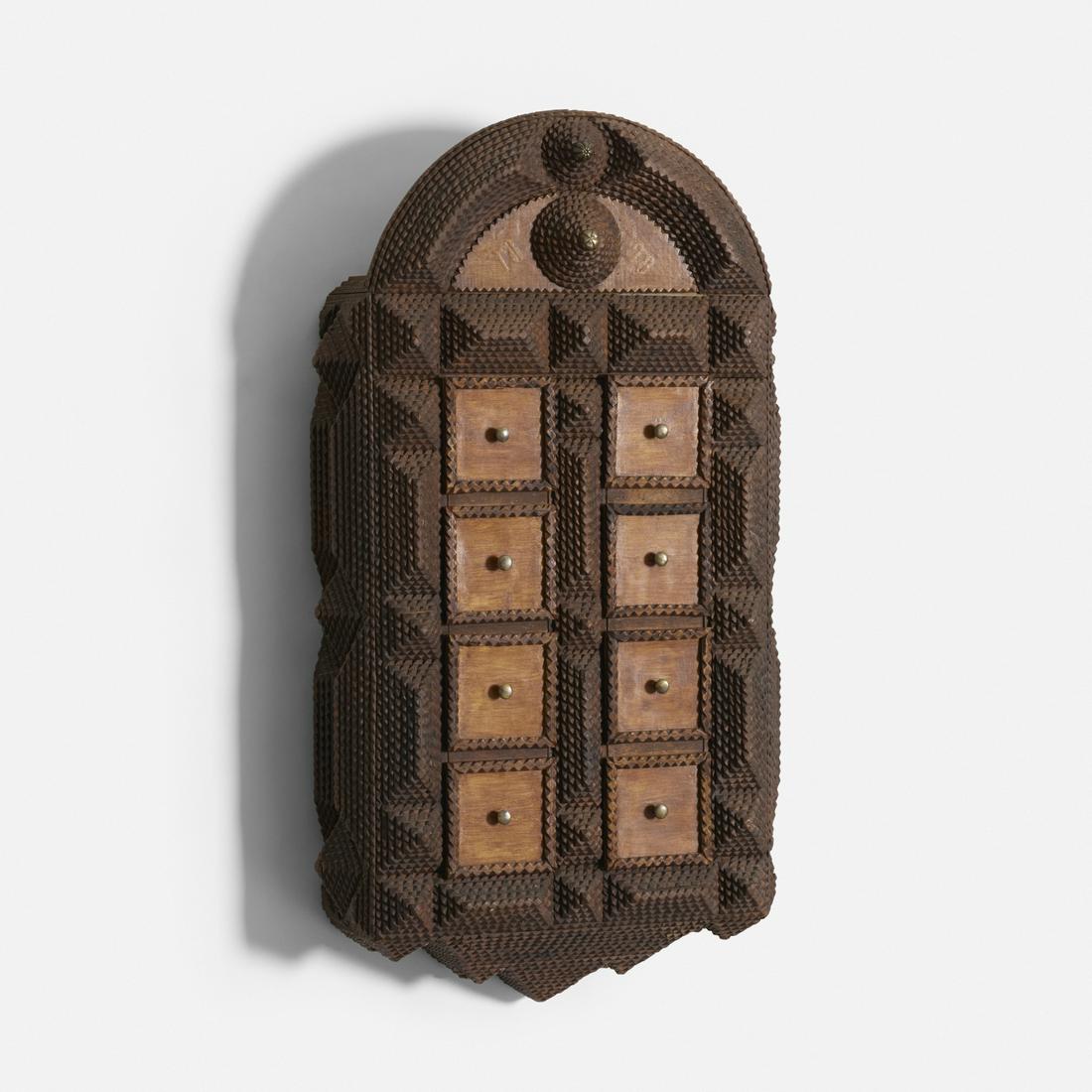 Tramp Art, wall cabinet: Tramp Art wall cabinet USA, 1898 chip-carved wood, lacquered wood, brass, steel 19 w × 6 d × 34 h in (48 × 15 × 86 cm) Cabinet features eight drawers. Dated to top '1898'.