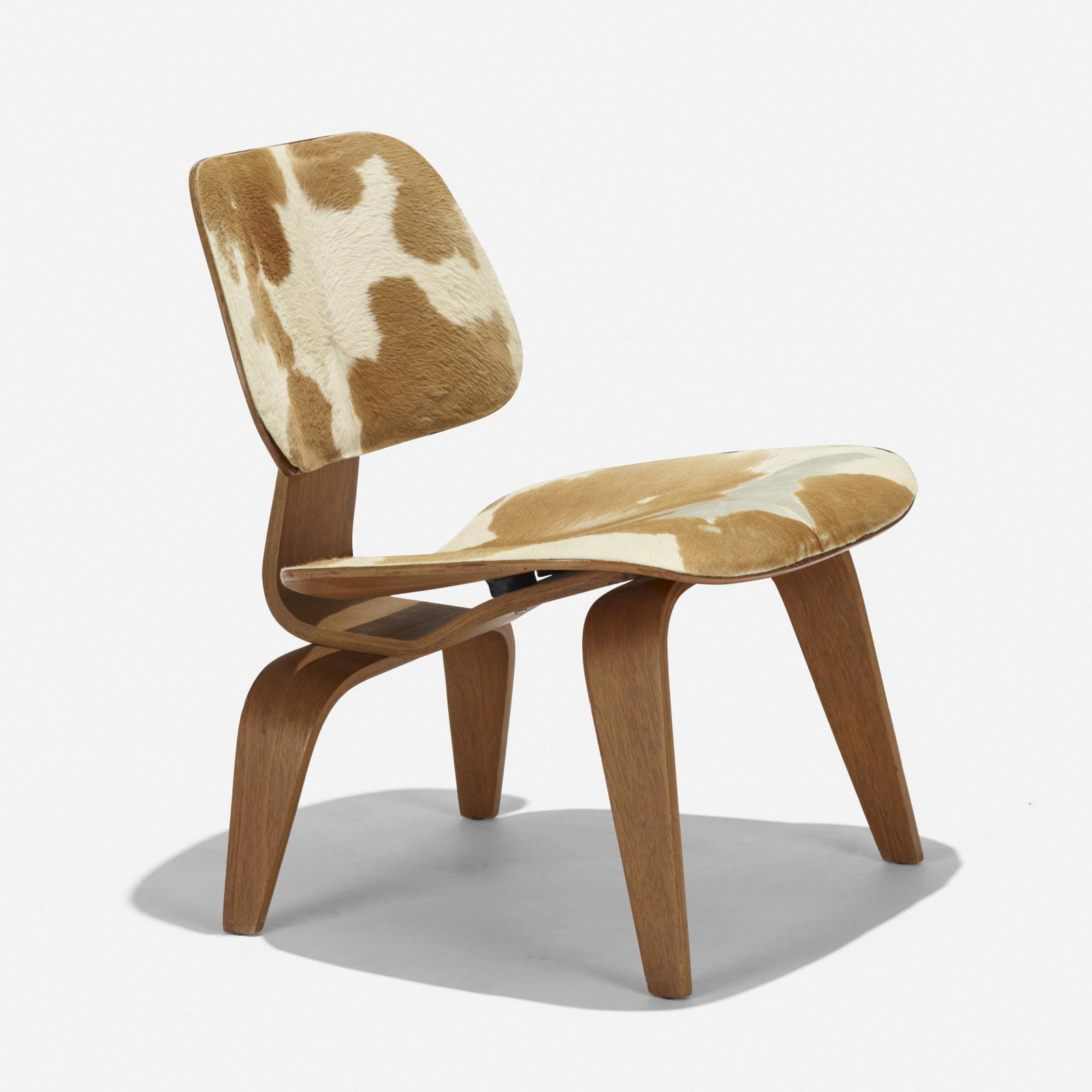 Charles and Ray Eames, LCW-1: Charles and Ray Eames LCW-1 Herman Miller USA, 1945 slunk skin, ash plywood, rubber 22 w × 23 d × 27 h in (56 × 58 × 69 cm) Partial foil manufacturer's label to undersi