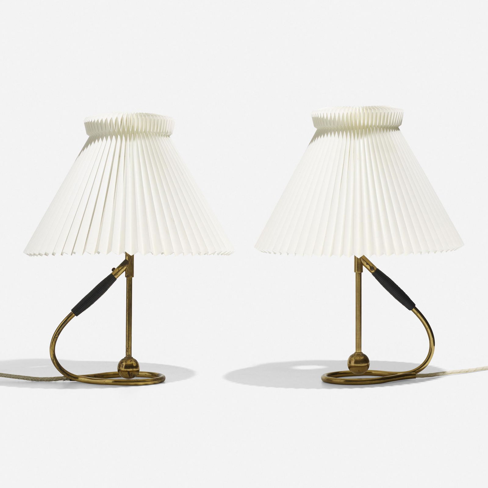Kaare Klint, table lamps model 306, pair: Kaare Klint table lamps model 306, pair Le Klint LampeskaermeDenmark, 1945brass, parchment, lacquered rattan13 dia × 15.75 h in (33 × 40 cm) Literature: Kaar