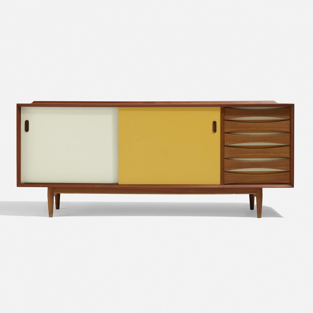 Arne Vodder, cabinet: Arne Vodder cabinet Sibast FurnitureDenmark, c. 1960teak, lacquered wood72 w × 19.5 d × 30.5 h in (183 × 50 × 77 cm) Cabinet features six drawers and two sliding door concealing three adjus