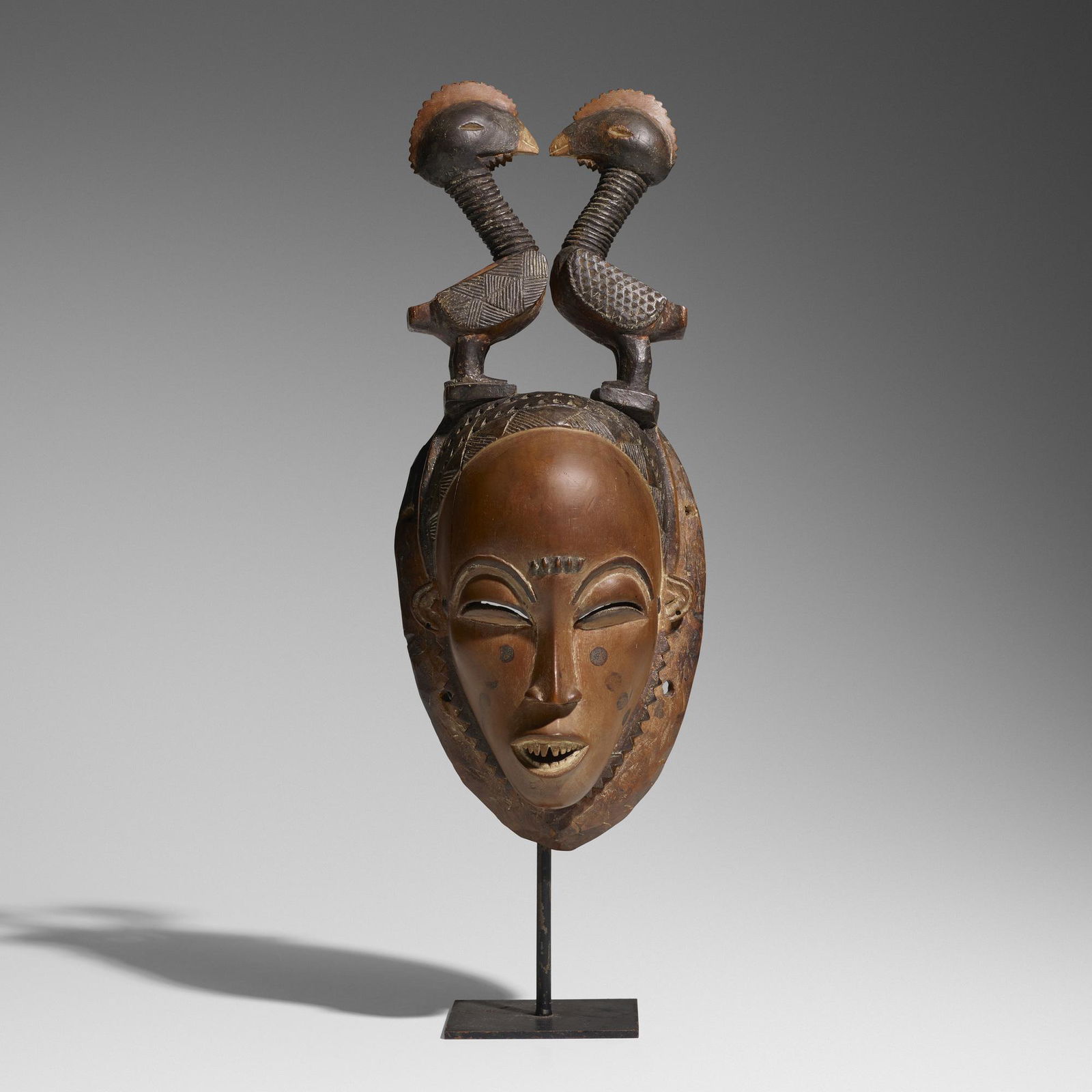 Yaure artist, Mblo (portrait mask): Yaure artist Mblo (portrait mask) Cote d'Ivoire, early 20th centurycarved wood13.25 h × 4.75 w × 4 d in (34 × 12 × 10 cm) Sold with stand.Sold with a digital copy of the invoice from Arcade Galle