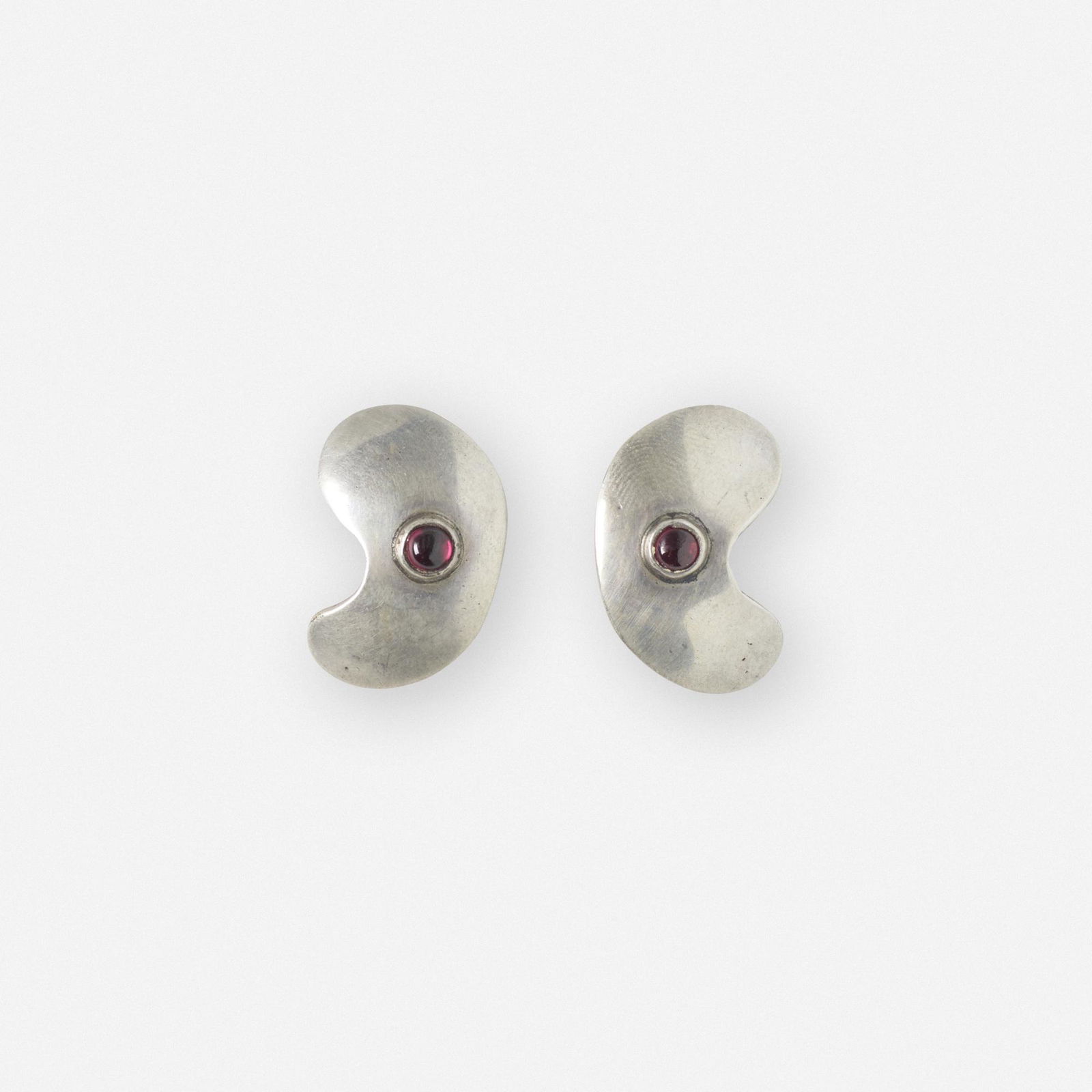 Sam Kramer, pair of earrings: Sam Kramer pair of earrings USA, c. 1955sterling silver, garnet cabochon1 h × .75 w × .5 d in (3 × 2 × 1 cm) Impressed artist's cipher to reverse of one example 'Sterling'