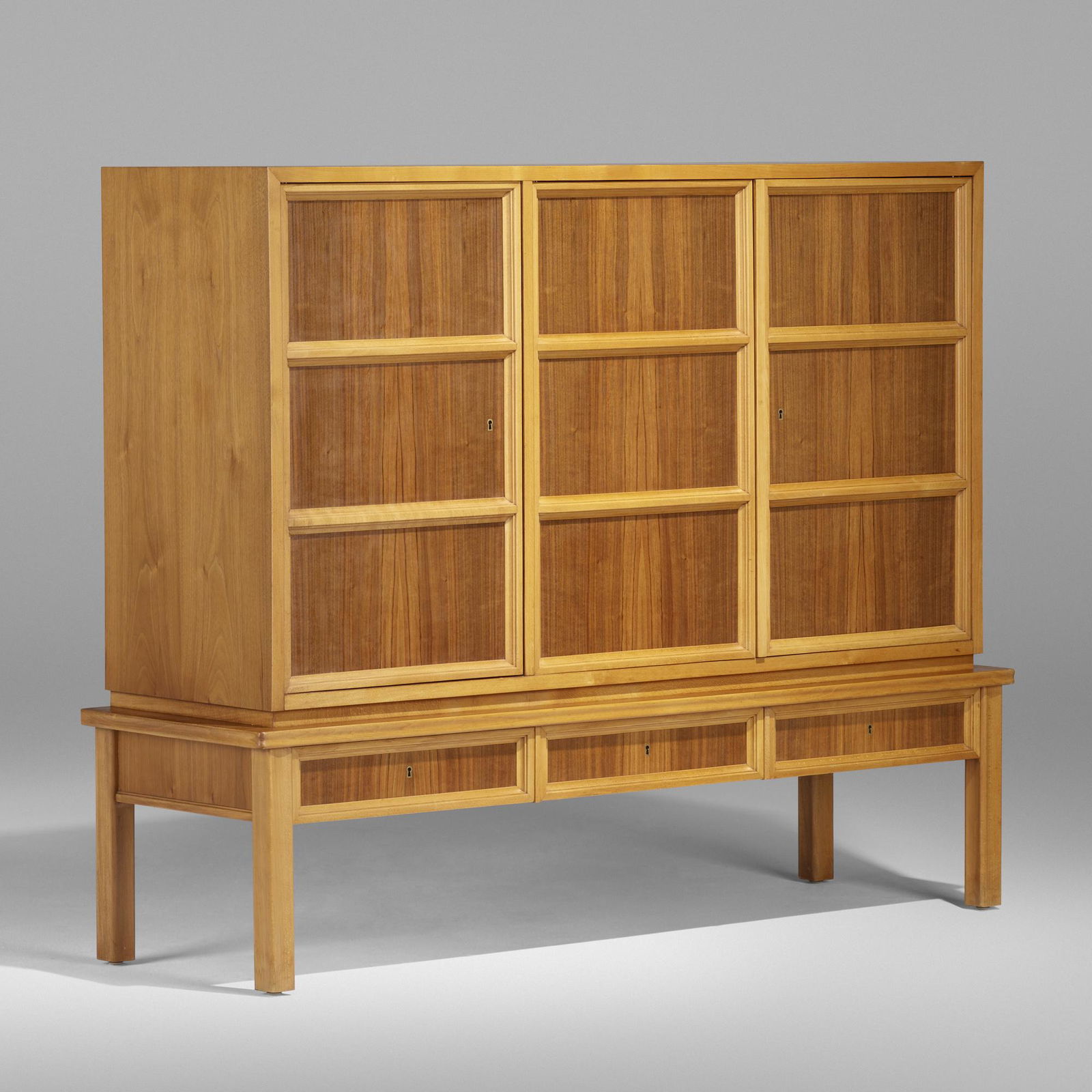 Oscar Nilsson, attribution, cabinet: Oscar Nilsson, attribution cabinet Sweden, c. 1940walnut, beech62.25 w × 19 d × 49.25 h in (158 × 48 × 125 cm) Cabinet features three drawers beneath three doors concealin