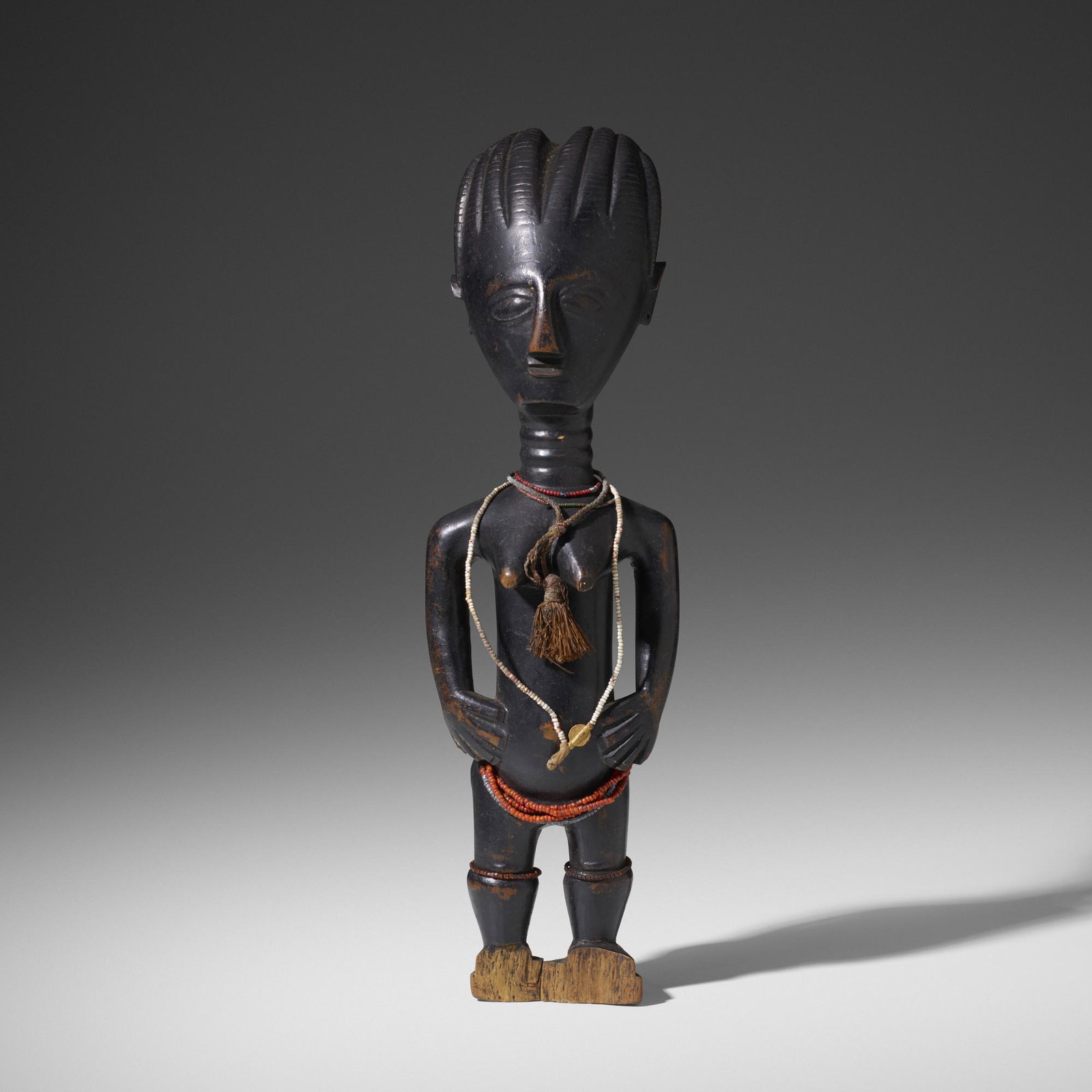 Asante (Ashanti) artist, female figure: Asante (Ashanti) artist female figure Ghana, 20th century carved wood, beads 4 w × 3 d × 13.5 h in (10 × 8 × 34 cm) Provenance: Collection of Mark Isaacson