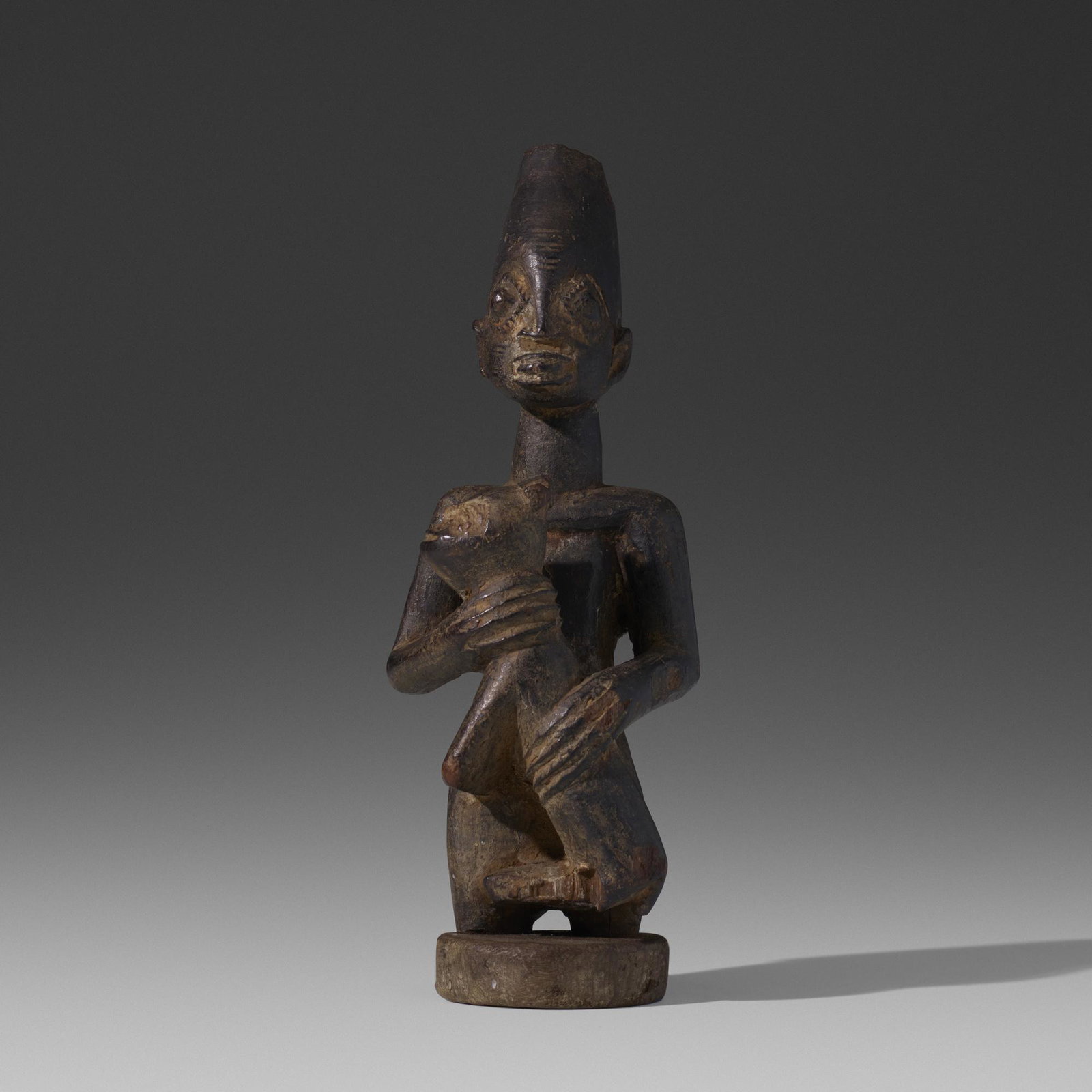 Yoruba artist, figure with dog: Yoruba artist figure with dog Nigeria, 20th century carved wood 3 w × 2.5 d × 8 h in (8 × 6 × 20 cm) Provenance: Collection of Mark Isaacson and Greg Nacozy