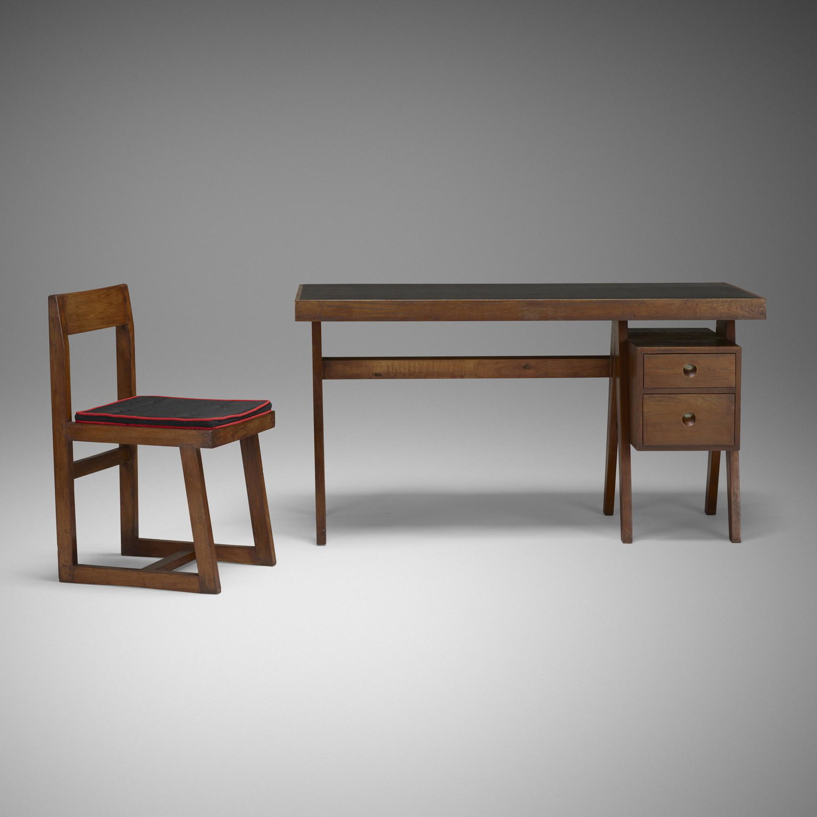 Pierre Jeanneret, desk and chair from Chandigarh: Pierre Jeanneret desk and chair from Chandigarh France/India, c. 1960 teak, leather, cane, linen 54 w × 27 d × 29 h in (137 × 69 × 74 cm) Chair measures: 16.75 w x 18.5 d x
