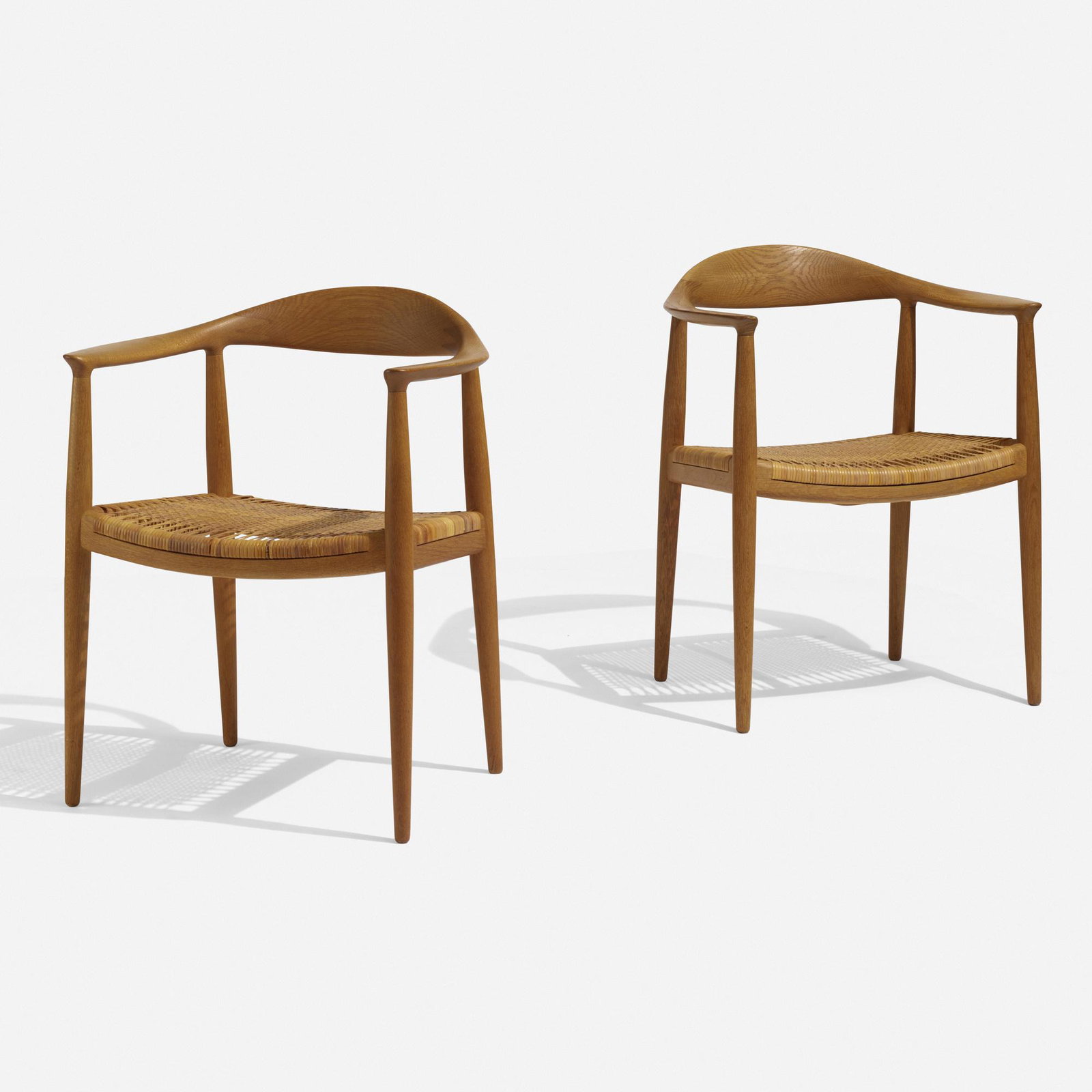 Hans J. Wegner, The Chairs, pair: Hans J. Wegner The Chairs, pair Johannes Hansen Denmark, 1949 oak, cane 24.75 w × 21 d × 30 h in (63 × 53 × 76 cm) Branded manufacturer's mark to underside of each example 'Johannes Hansen Cop