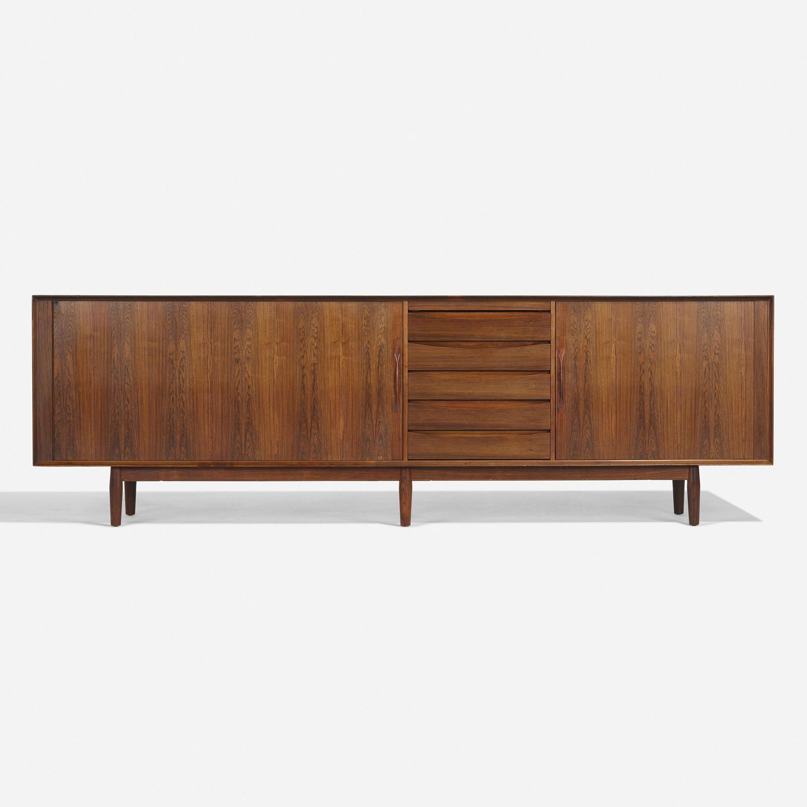 Arne Vodder, cabinet: Arne Vodder cabinet Sibast FurnitureDenmark, c. 1960rosewood, leather98 w × 19.25 d × 30.75 h in (249 × 49 × 78 cm) Cabinet features five drawers beneath a pull-out leather surface and two