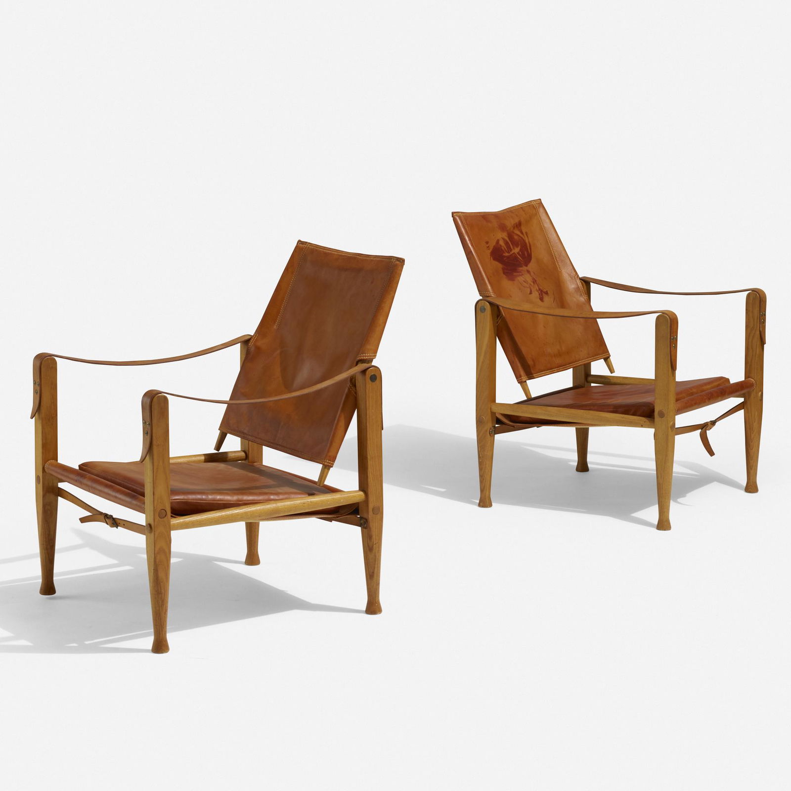 Kaare Klint, Safari chairs, pair: Kaare Klint Safari chairs, pair Rud. Rasmussens SnedkerierDenmark, 1933 / c. 1970leather, ash, brass22.5 w × 26 d × 31.5 h in (57 × 66 × 80 cm) Stamped manufacturer's mark to strap on backr