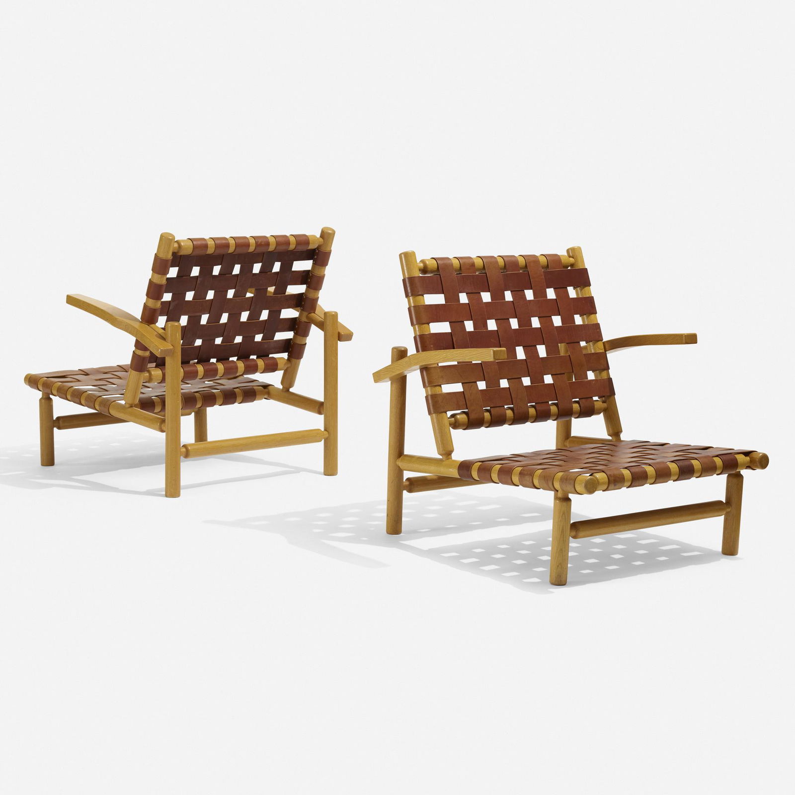 Ilmari Tapiovaara, lounge chairs: Ilmari Tapiovaara lounge chairs for the Rauma-Repola Company, pair Finland, c. 1955oak, leather30.5 w × 32 d × 30.5 h in (77 × 81 × 77 cm) Provenance: Rauma-Repola Company, Helsi