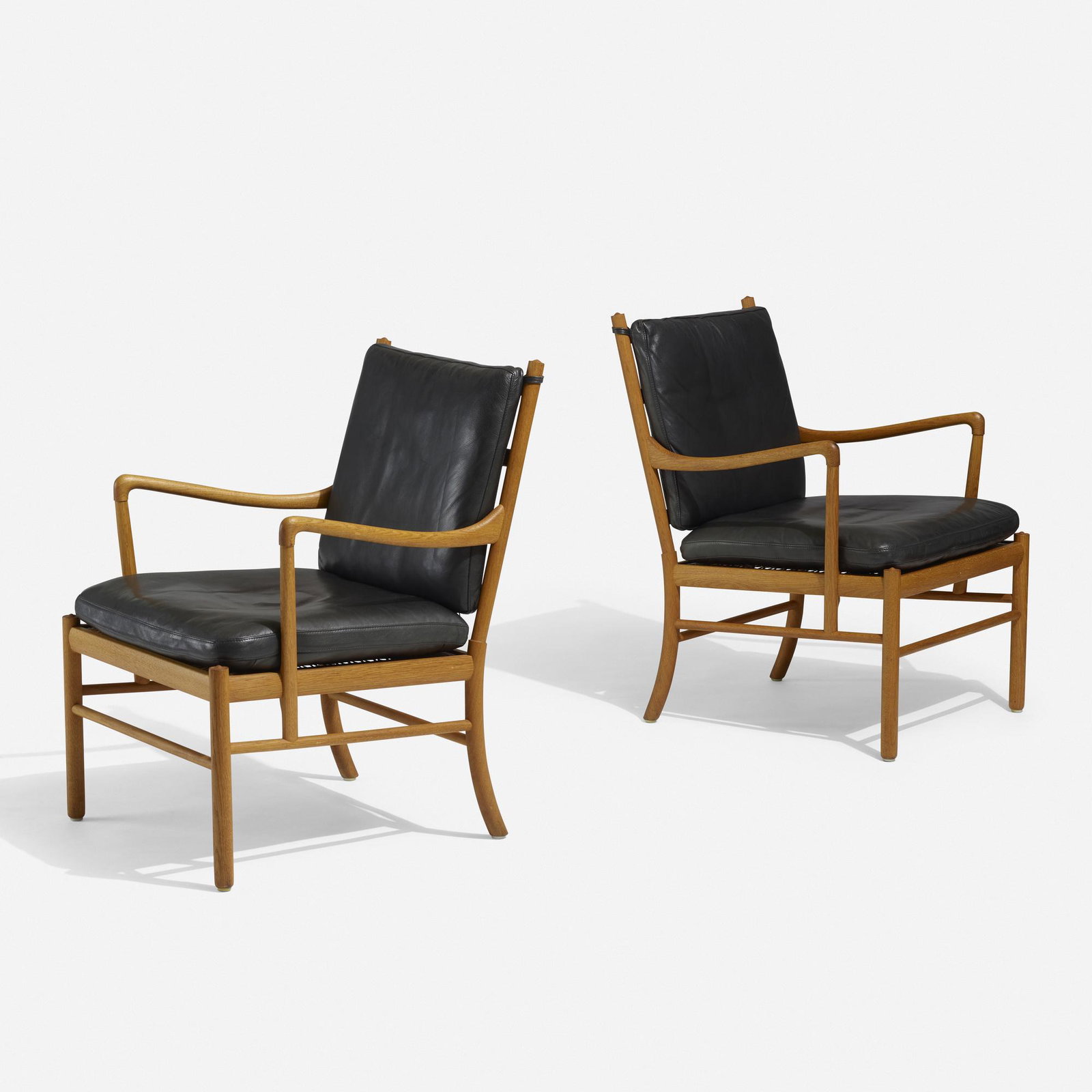 Ole Wanscher, Colonial chairs, pair: Ole Wanscher Colonial chairs, pair Poul Jeppesen Denmark, 1949 oak, leather, cane 25.25 w × 25.5 d × 33.5 h in (64 × 65 × 85 cm) Disc manufacturer's label to underside of each example 'Made in
