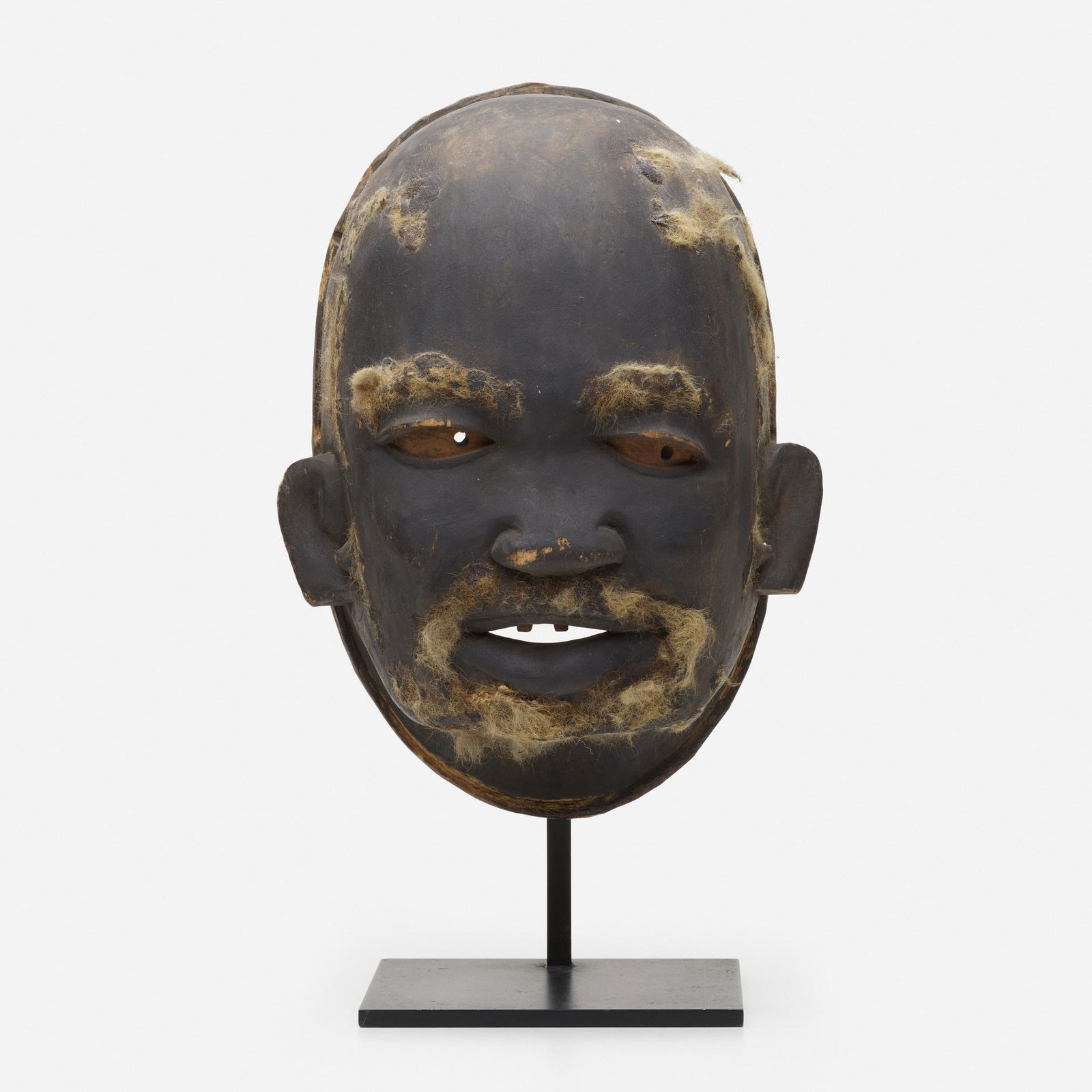 Makonde artist, Lipiko mask: Makonde artist Lipiko mask Tanzania, 20th centurycarved and painted wood with applied hair11 h × 8 w × 5 d in (28 × 20 × 13 cm) Provenance: Collection of